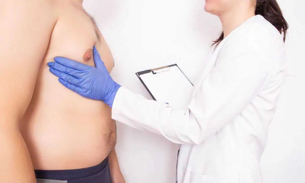 Doctor examining male patient for gynecomastia surgery in Salisbury and Berlin, MD