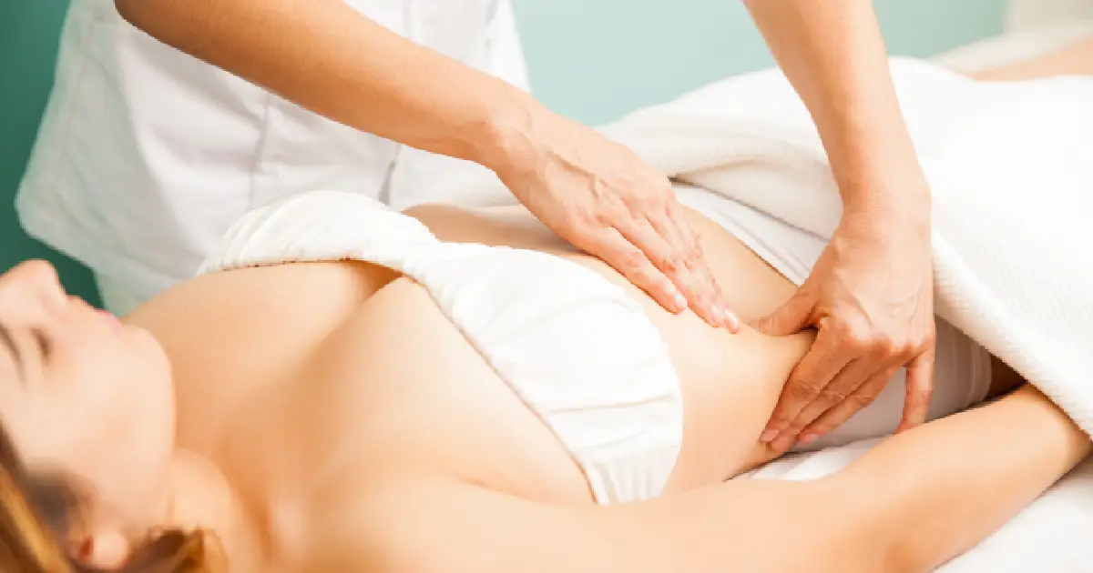 Lymphatic massage on a woman's abdomen for circulation and detox